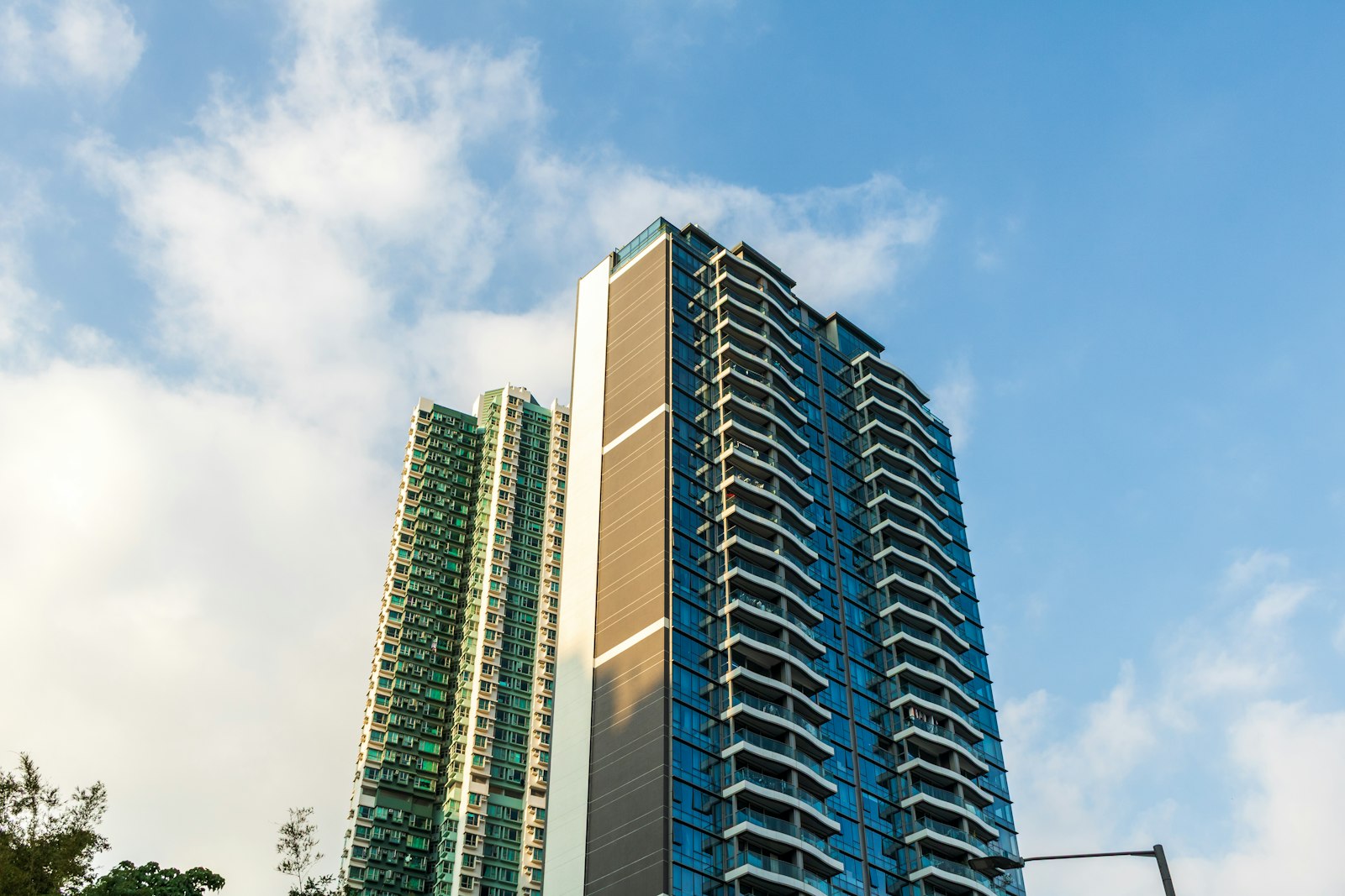 Residential tower, Kochi: glass-balconied residential tower at dusk